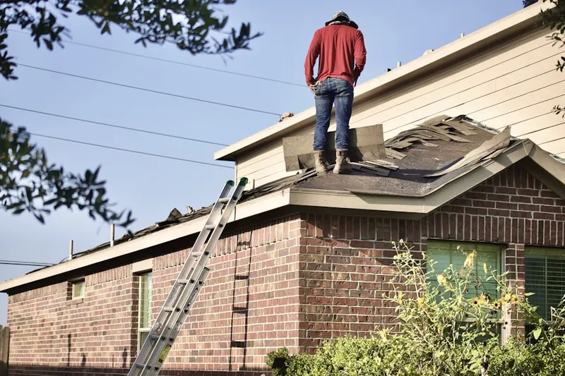 Professional roofer working on a residential roof in Star